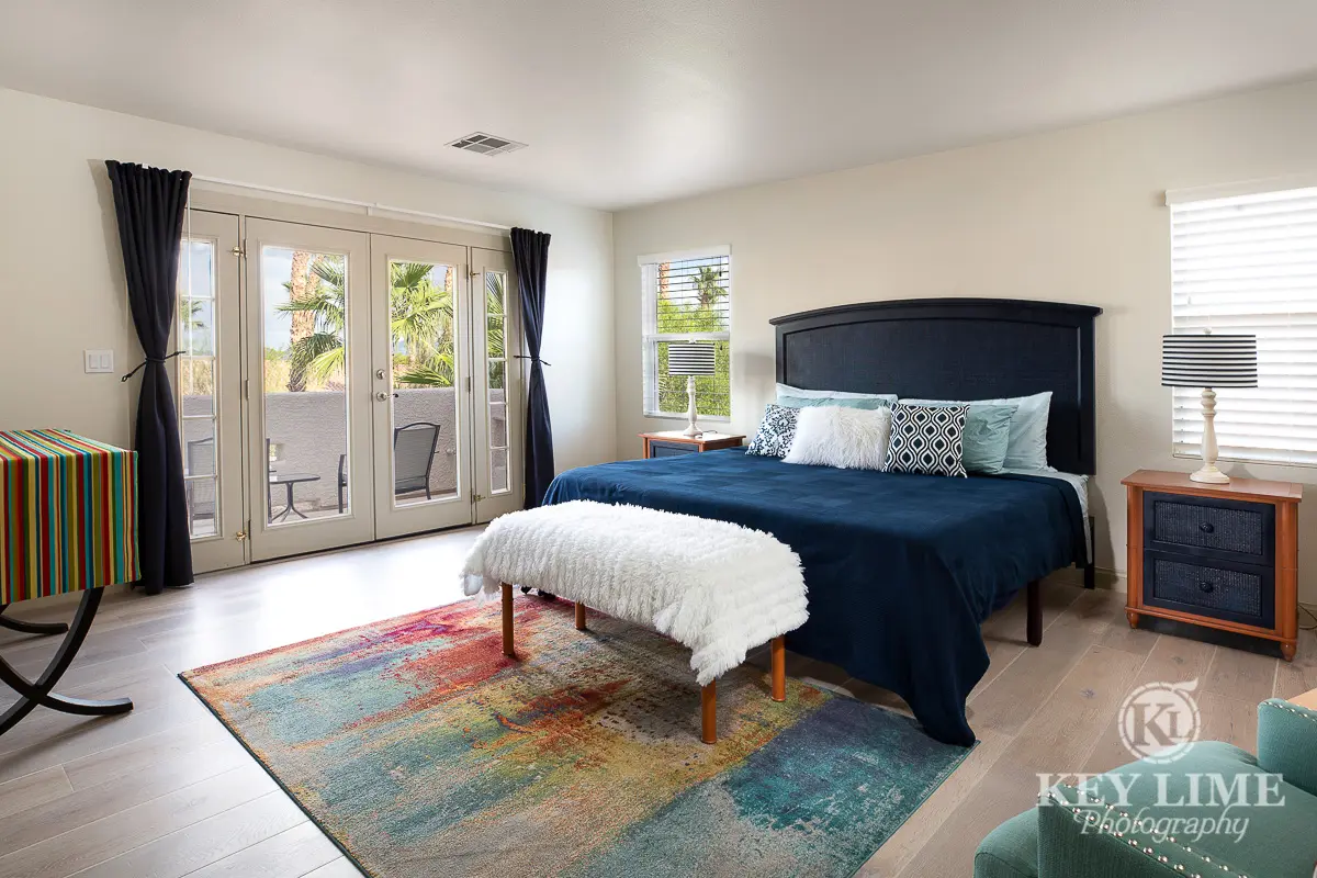 Master bedroom real estate photography. Navy blue king size bed.