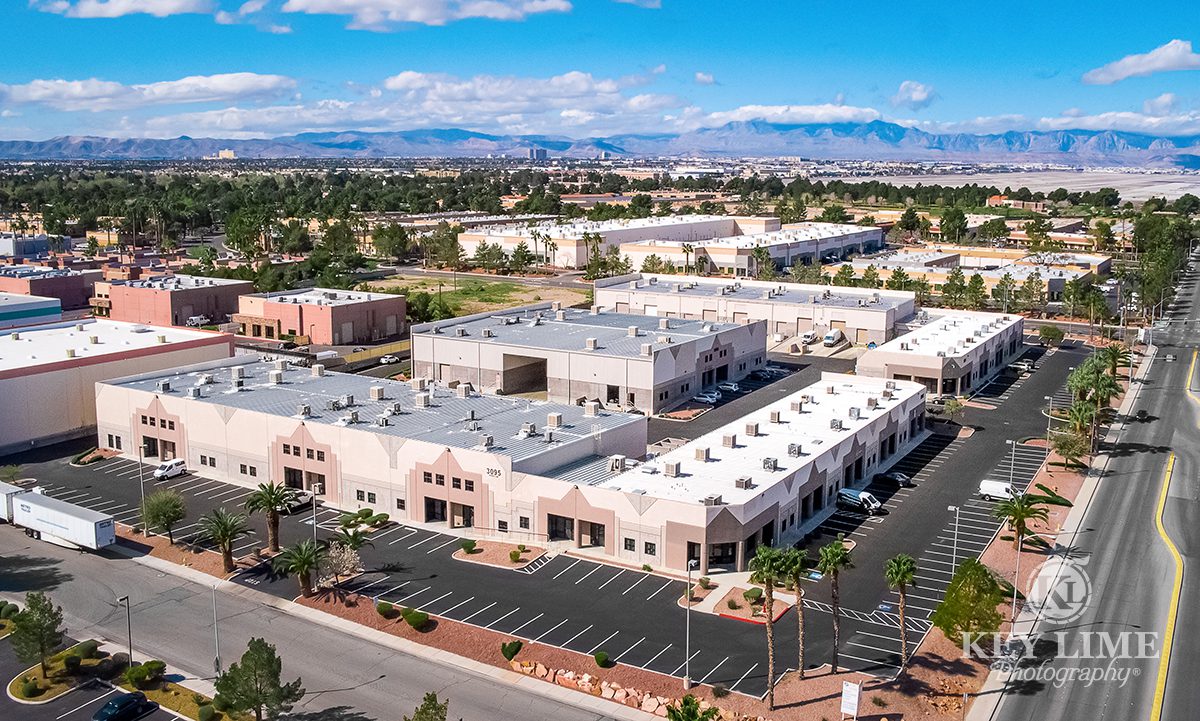 Drone architecture photographer photo of business center in Las Vegas. Vivid blue sky and lush green neighborhoods.