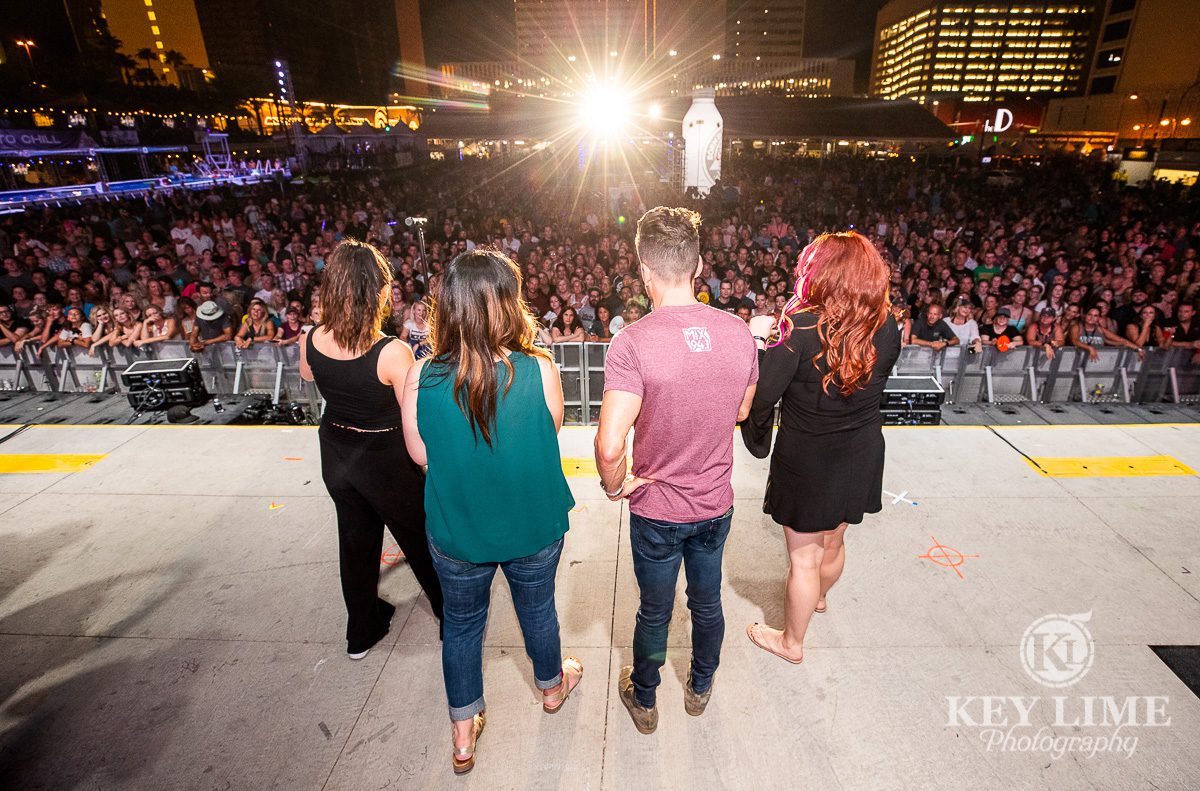 Radio DJs onstage. Point of view from the stage looking over DJ's shoulders at an ocean of people. Sold out event center during Bite of Las Vegas 2019
