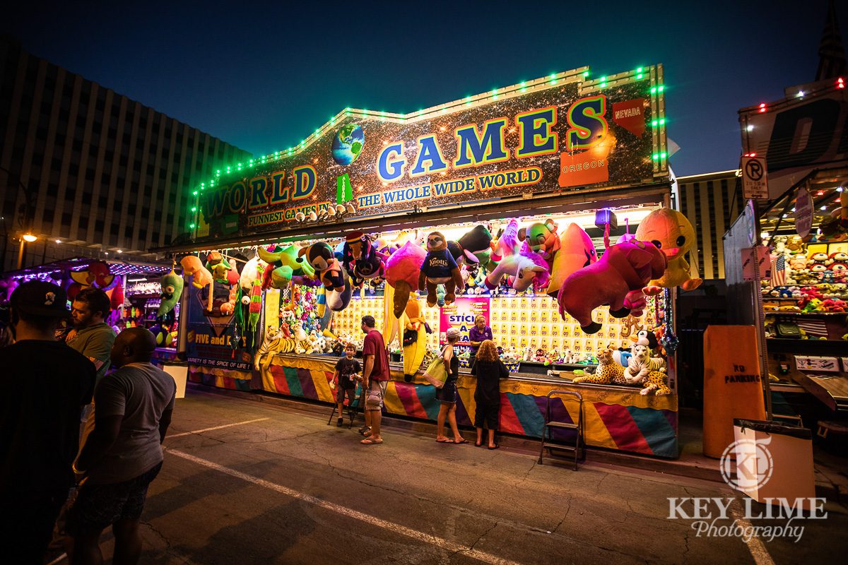 Photo of carnival games at Bite of Las Vegas 2019. Vivid pink and green colors with flashy bulbs and stuffed animals.