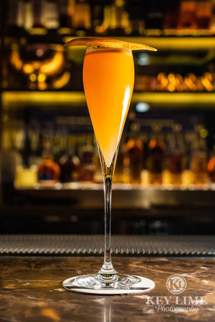 Cocktail image. Orange drink in Grappa Glass.