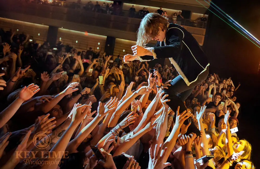 Iconic photo of Cage the Elephant by concert photographer Key Lime Photo. Lead singer Matt Schultz performing his signature crowd surf.