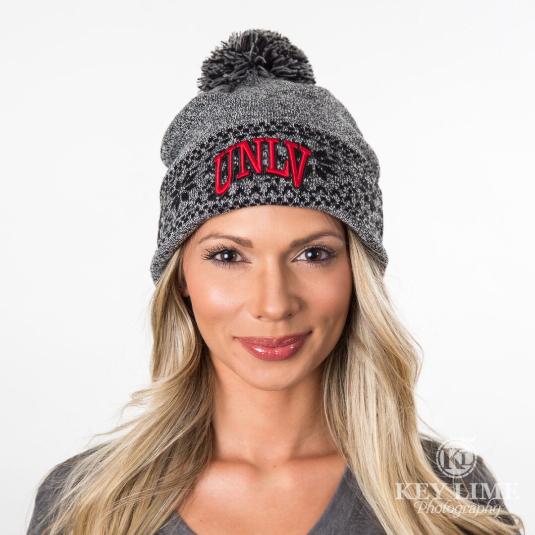 UNLV warm beanie hat for women and unisex. Pretty smiling model
