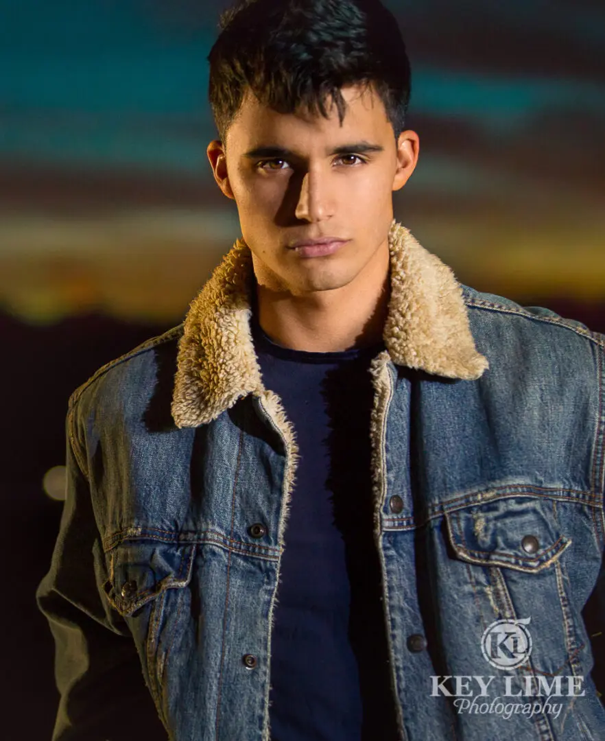 Product photography in Las Vegas. Young, dark hair male modeling jean jacket with wool collar.
