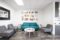 Modern waiting area with teal sofa, gray chairs, and wall art, photographed by Key Lime Photography inside a Las Vegas commercial office space.